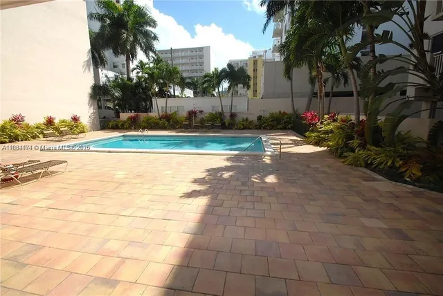 a view of a swimming pool and a yard