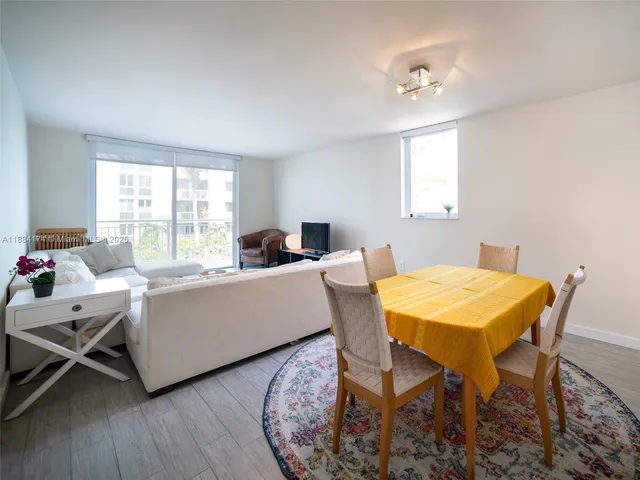 a living room with furniture a window and a table