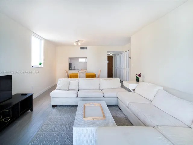 a large white bed in a white room