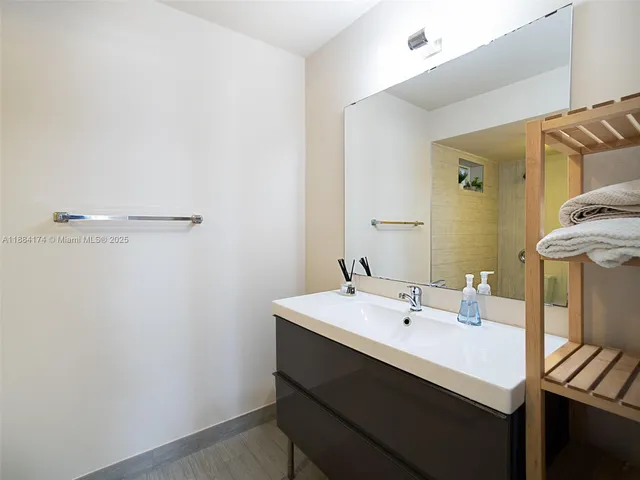 a bathroom with a sink a mirror and a toilet