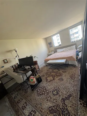 a bed sitting in a room next to a window