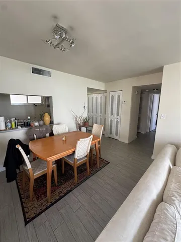 a living room with furniture a table and wooden floor