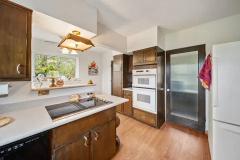 a kitchen with stainless steel appliances granite countertop a refrigerator and a sink