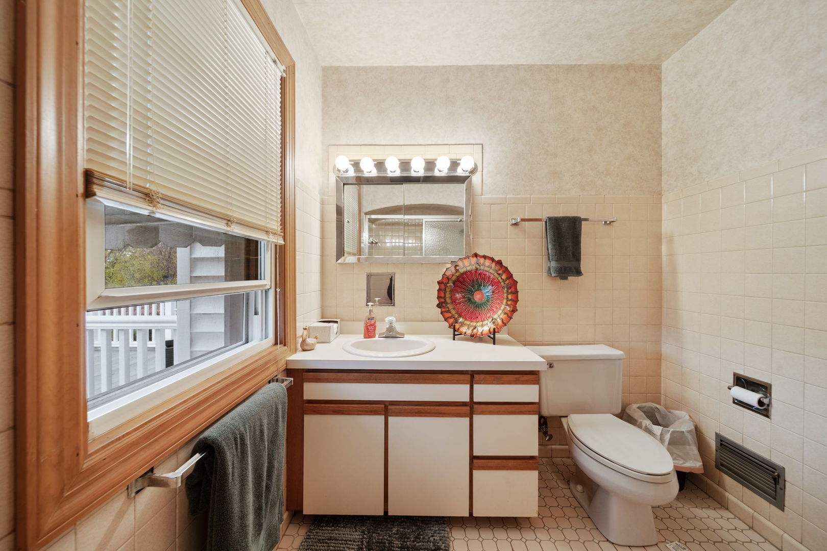 2619 York Road Oak Brook, IL 60523 - Photo 22 of 41 a bathroom with a sink a toilet and a window