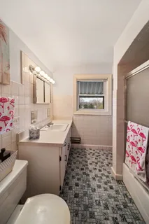 a bathroom with a sink toilet and shower