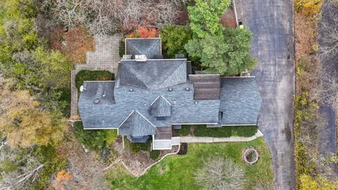an aerial view of a house with yard swimming pool and outdoor seating