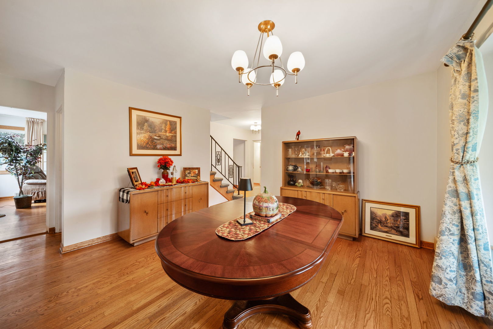 2619 York Road Oak Brook, IL 60523 - Photo 7 of 41 a view of a dining room with furniture a chandelier and wooden floor