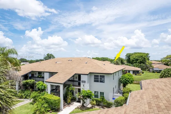 a aerial view of a house with yard and green space