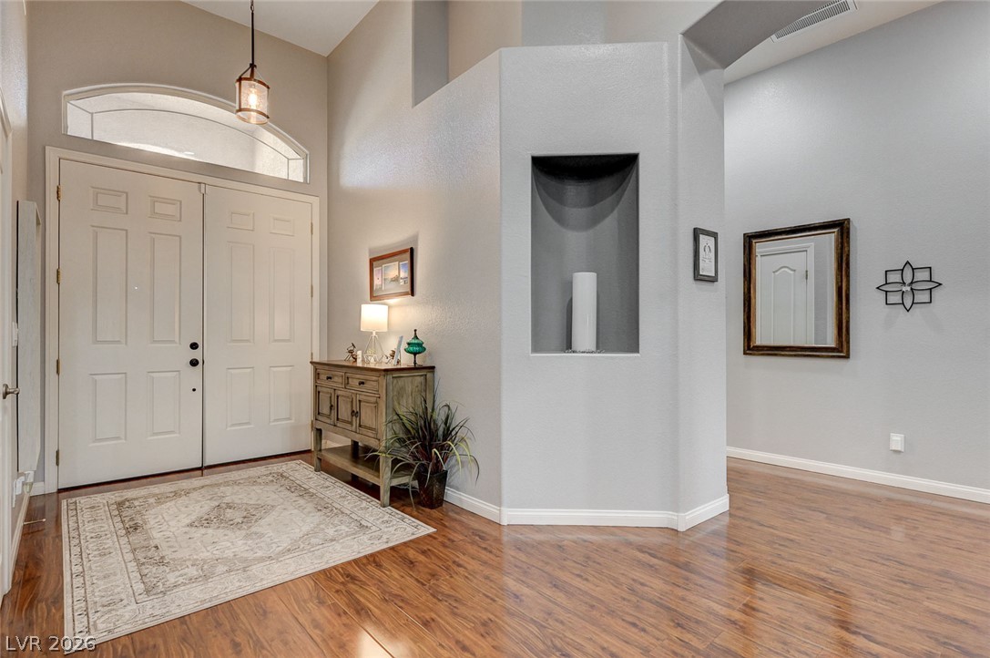 1604 Cattle Ranch Place Henderson, NV 89002 - Photo 12 of 99 A well-lit entry with soaring ceilings welcomes you into this inviting home.