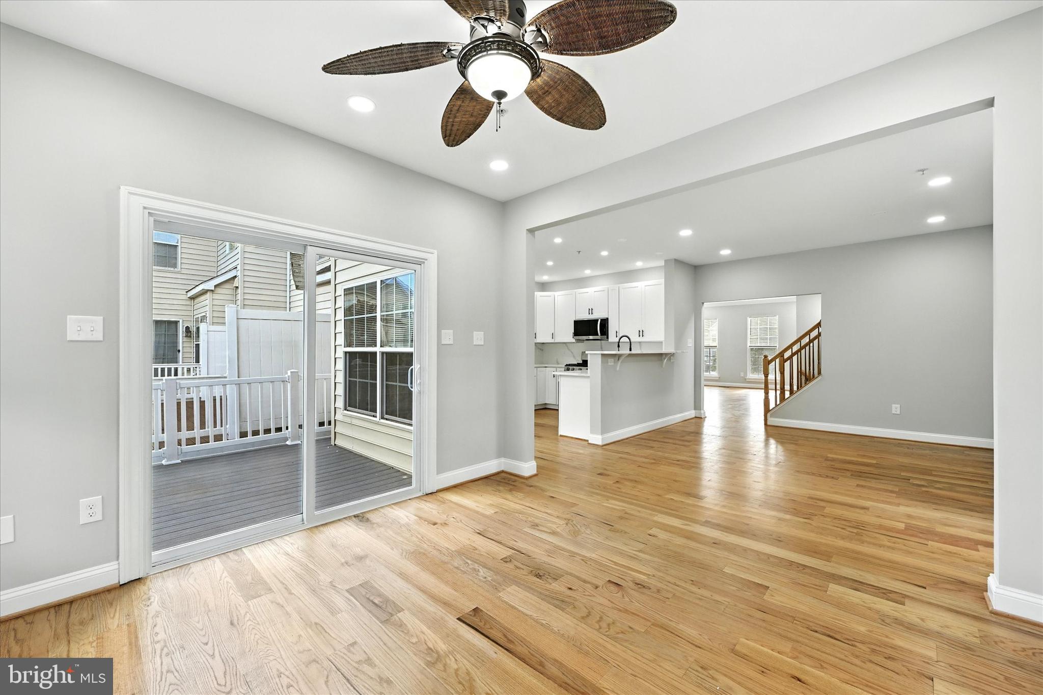 9828 Snow Bird Lane Laurel, MD 20723 - Photo 12 of 30 a view of an empty room with wooden floor and a kitchen