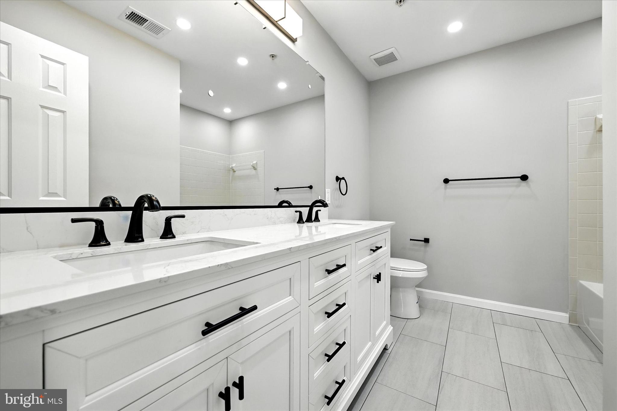 9828 Snow Bird Lane Laurel, MD 20723 - Photo 19 of 30 a bathroom with a double vanity sink and a mirror