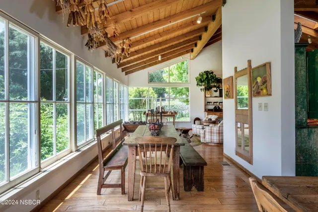 a view of a dining room with furniture window and outside view
