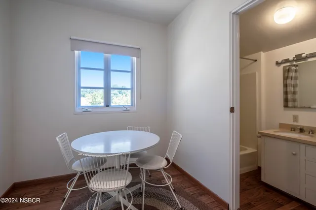 a view of a dining room with furniture and a chandelier