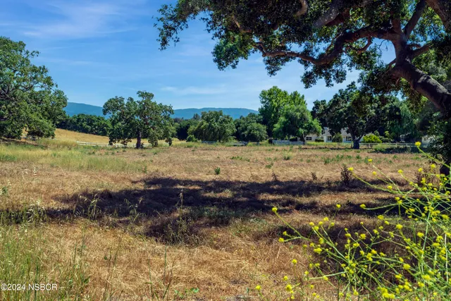 a view of a lake with beach and green space