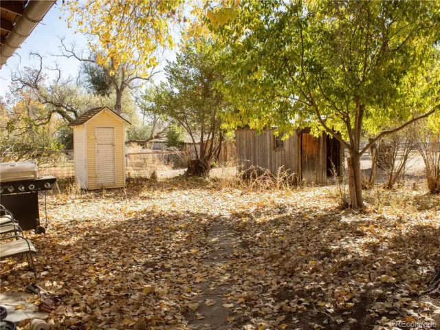 a front view of a house with a yard covered with snow