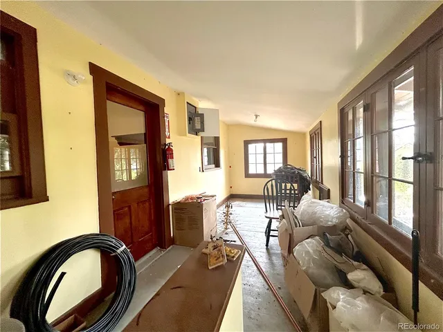 a living room with furniture a rug a fireplace and windows