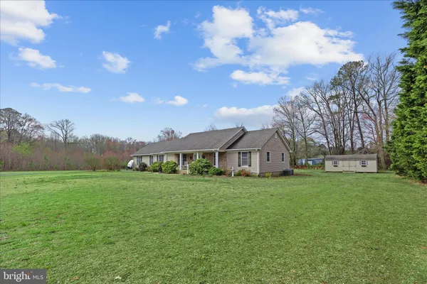 a view of a big yard with a house in the background