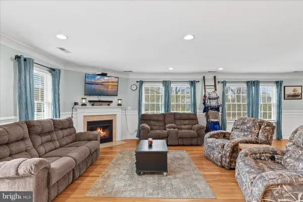 a terrace of a house with wooden floor outdoor seating and yard in the back