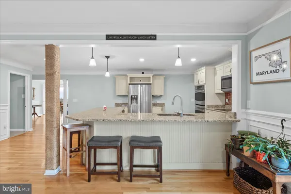 a kitchen with stainless steel appliances granite countertop a refrigerator and a stove