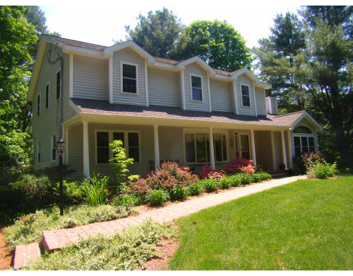 230 Hudson Road Stow, MA 01775 - Photo 1 of 1 a front view of a house with garden