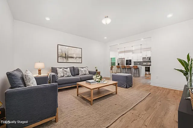 a living room with furniture and wooden floor