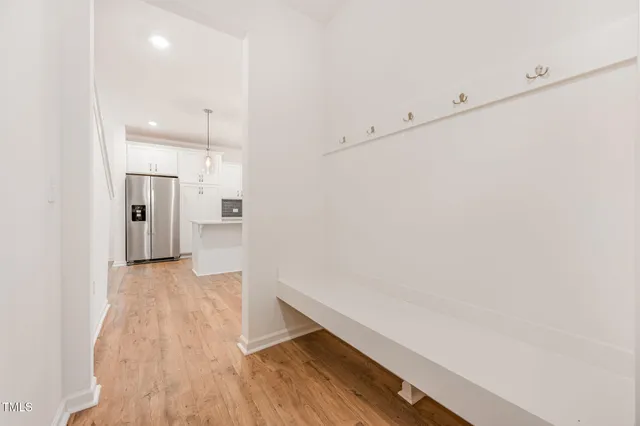a view of hallway with wooden floor