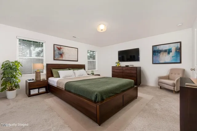 a bedroom with a bed and a couch