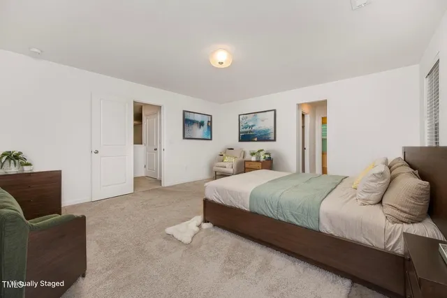 a spacious bedroom with a bed and furniture