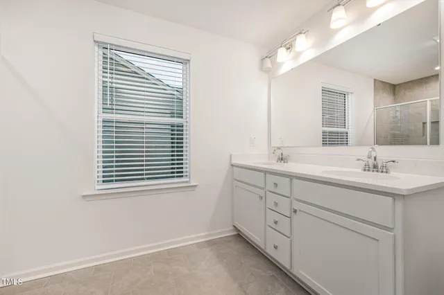 a bathroom with a sink a mirror and a window