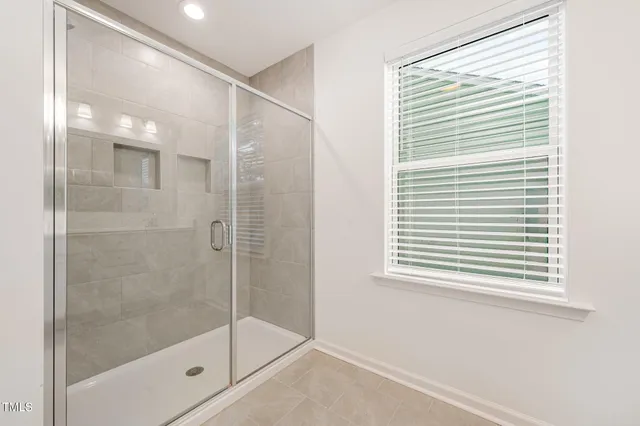 a bathroom with a shower and a window