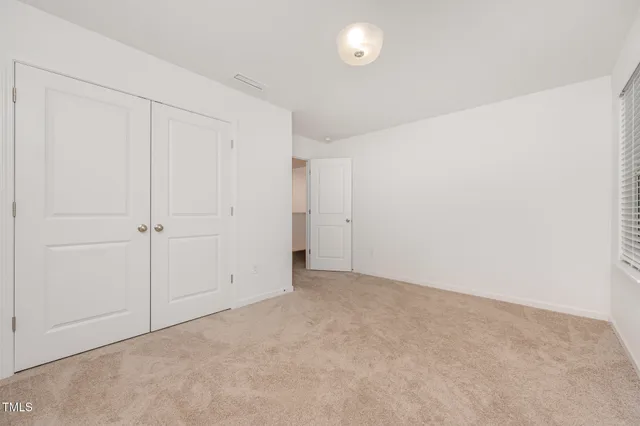 an empty room with closet area