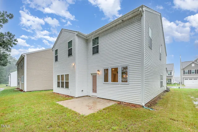a view of a backyard with a large tree