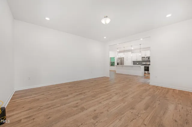 a view of a kitchen with wooden floor and a sink