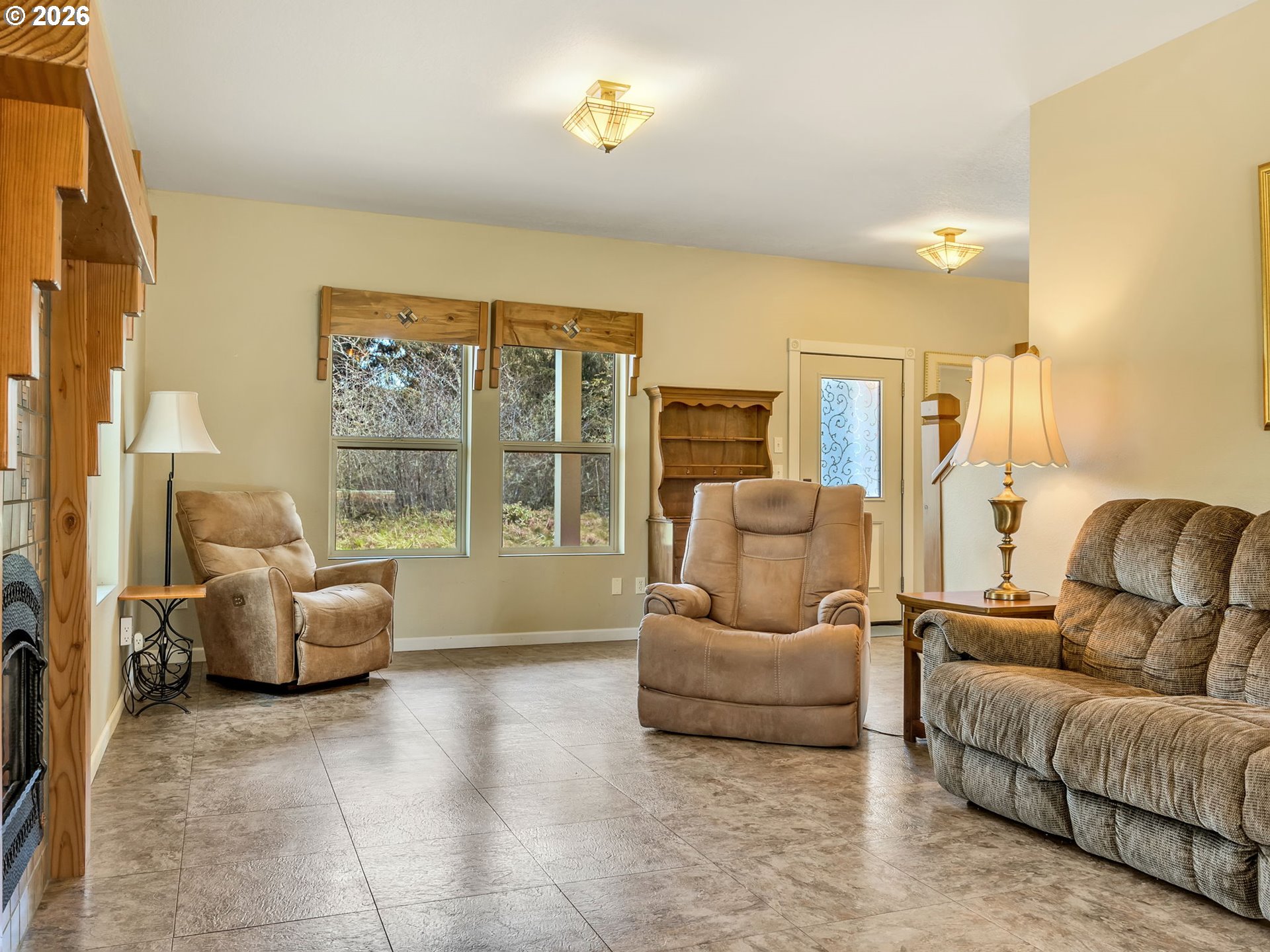 1077 Southwest Ridge Road Warrenton, OR 97146 - Photo 7 of 46 a living room with furniture and a large window