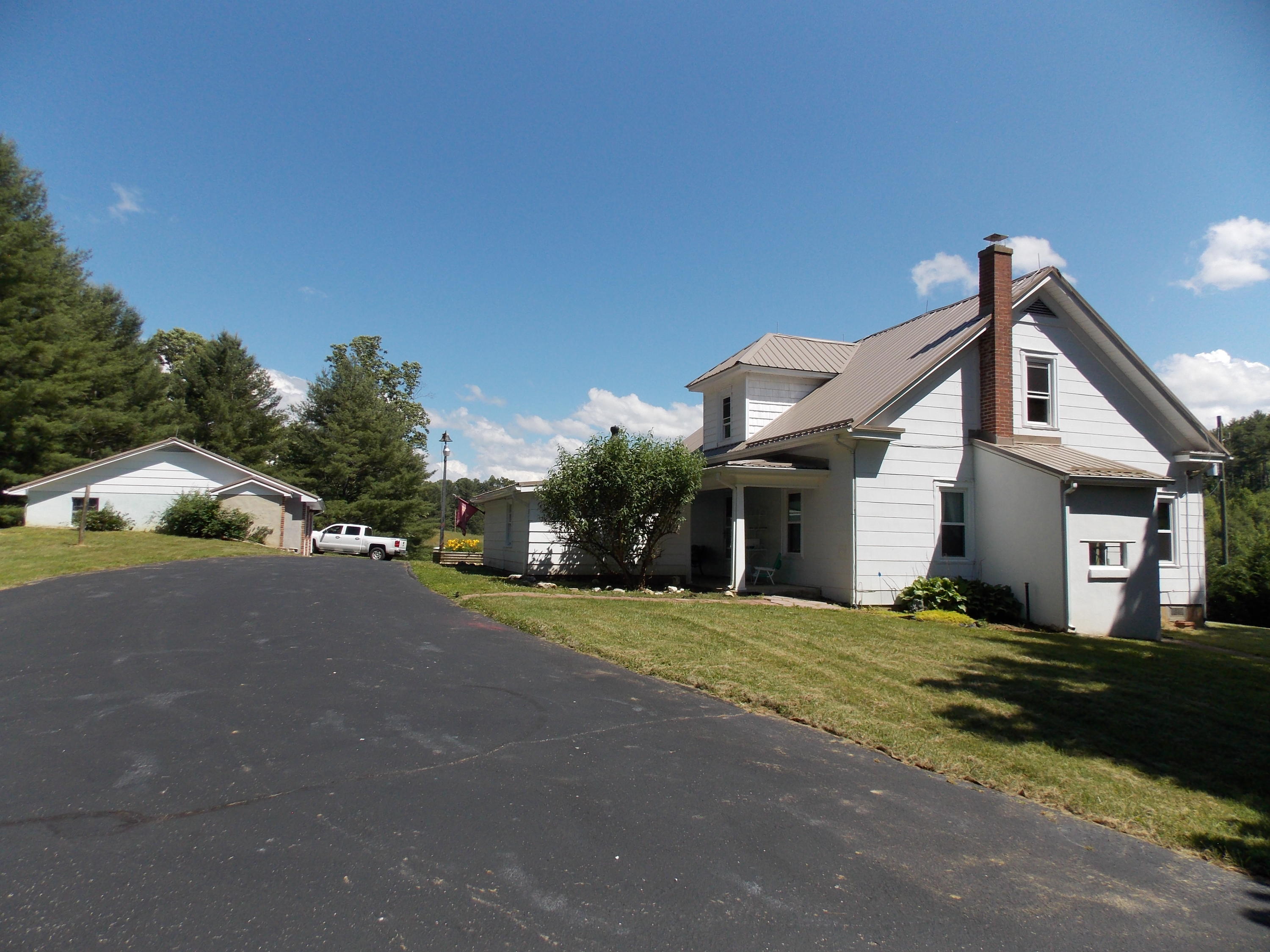 4147 Webbs Mill Road North Riner, VA 24149 - Photo 1 of 53 a front view of a house with a yard and garage