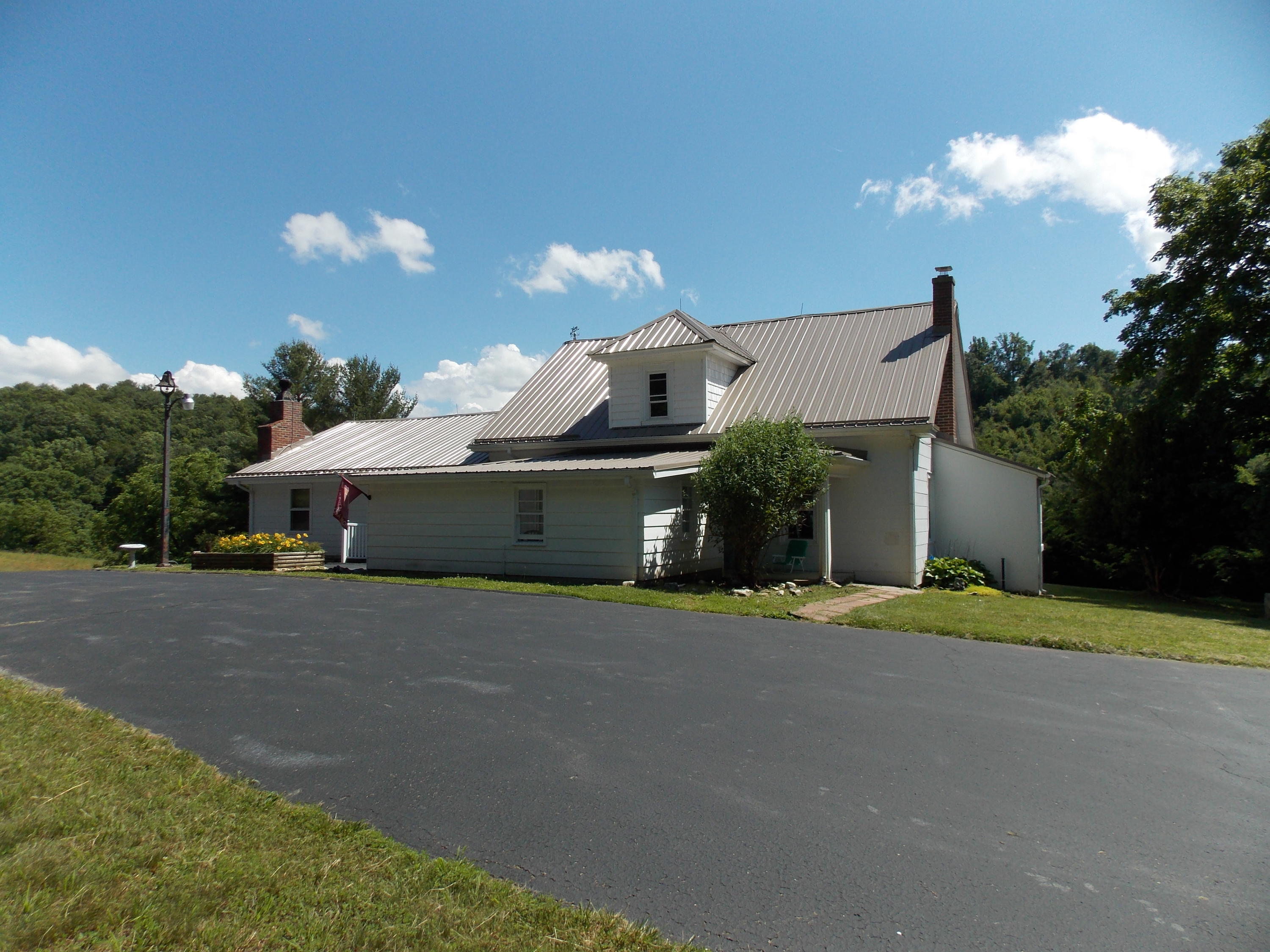 4147 Webbs Mill Road North Riner, VA 24149 - Photo 4 of 53 a front view of a house with a yard and garage