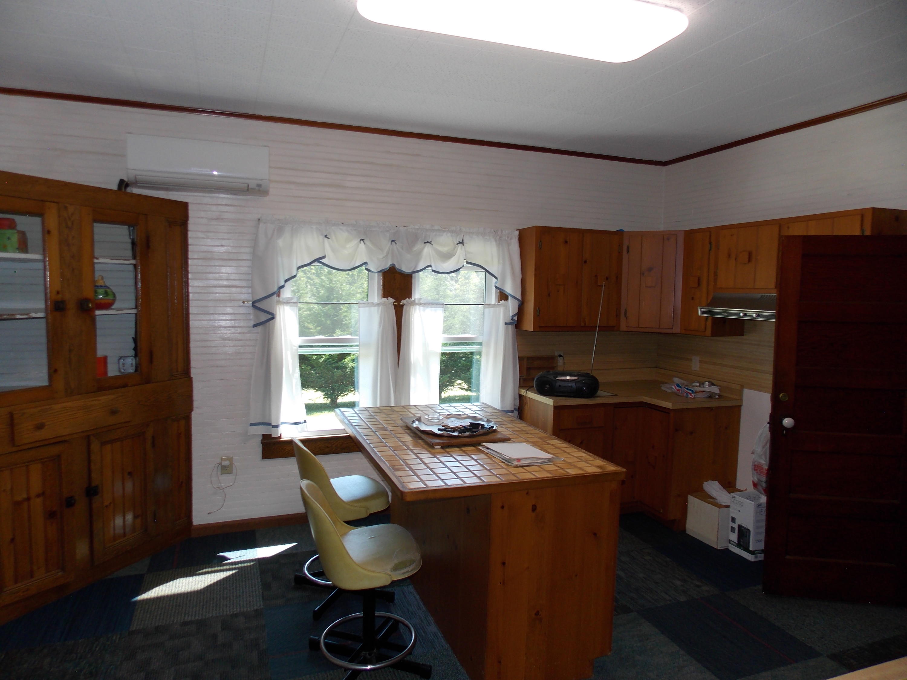 4147 Webbs Mill Road North Riner, VA 24149 - Photo 41 of 53 a kitchen with granite countertop a stove a sink dishwasher a dining table and chairs with wooden floor