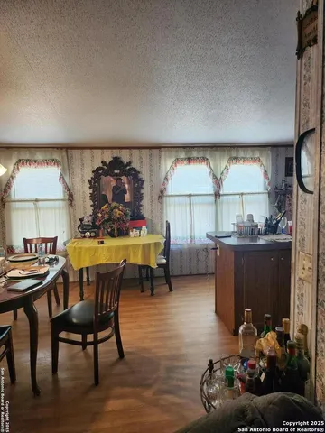a view of a dining room with furniture and window