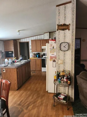 a kitchen with stainless steel appliances a stove a refrigerator a sink and cabinets