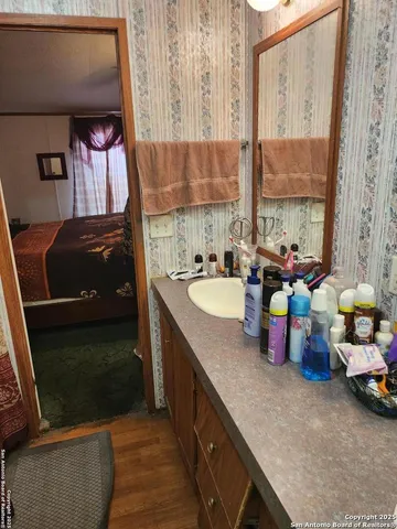 a bathroom with a sink mirror and window