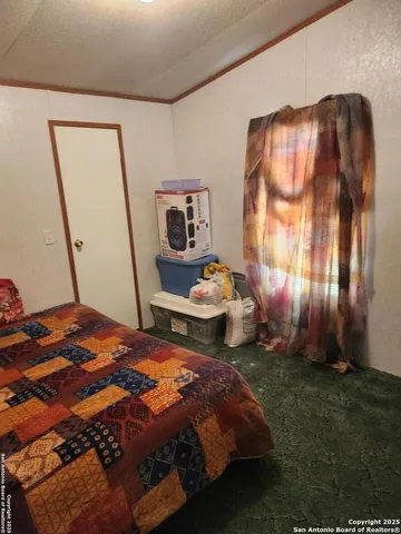 a bed sitting in a room next to a window