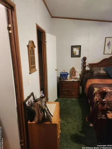 a bedroom with a bed and a mirror