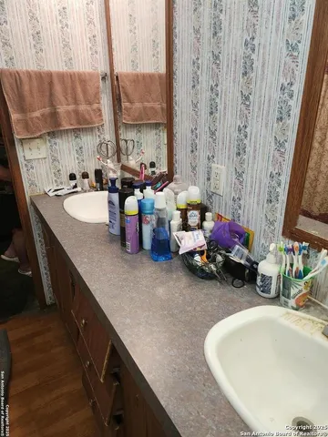 a kitchen with sink and view of living room