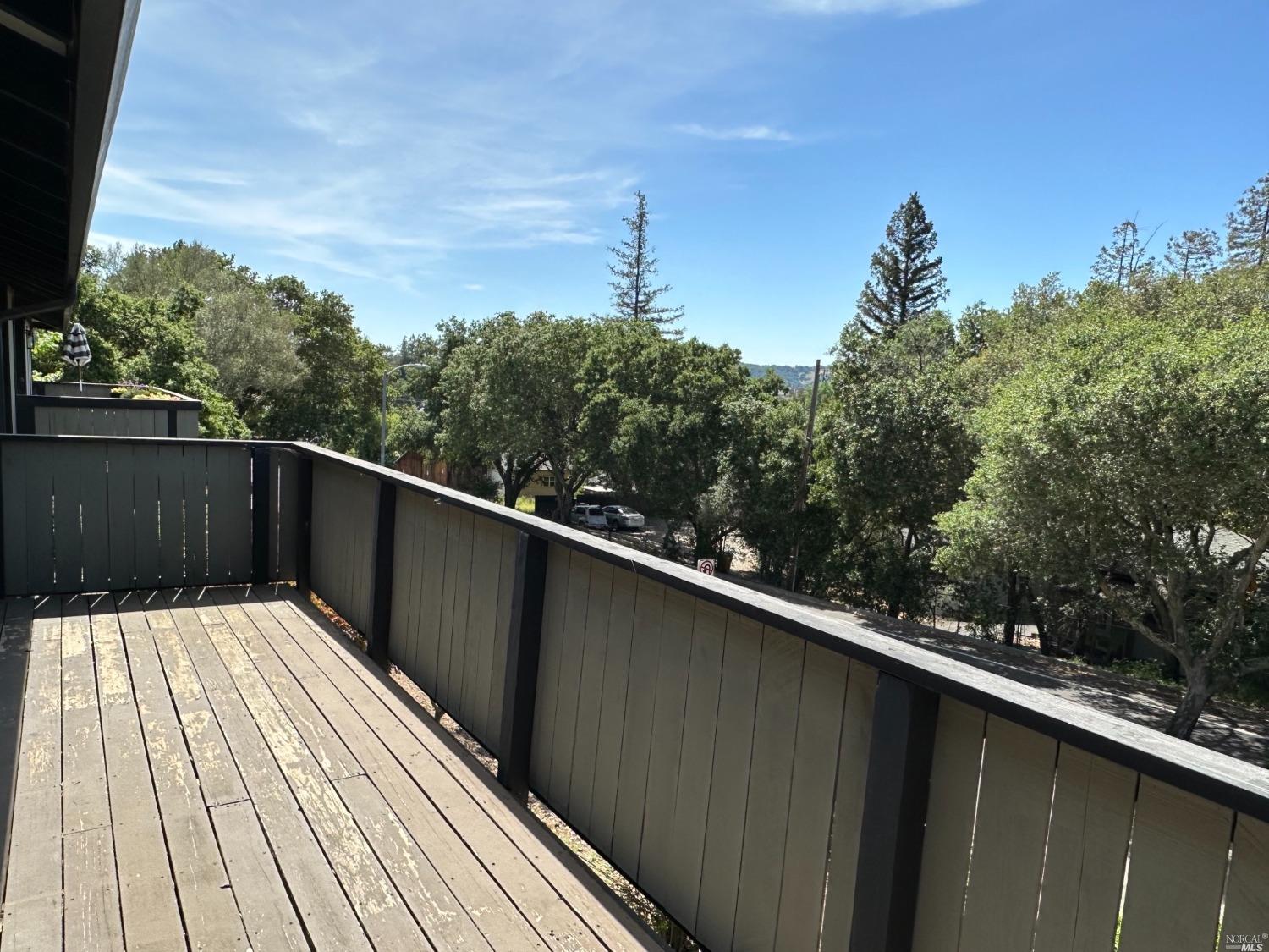 a balcony view with wooden floor and fence