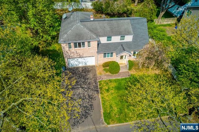 an aerial view of a house with a swimming pool