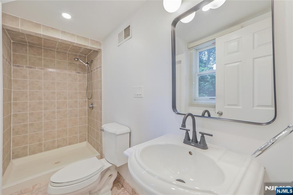 99 Park Avenue Cresskill, NJ 07626 - Photo 15 of 46 a bathroom with a sink toilet and shower