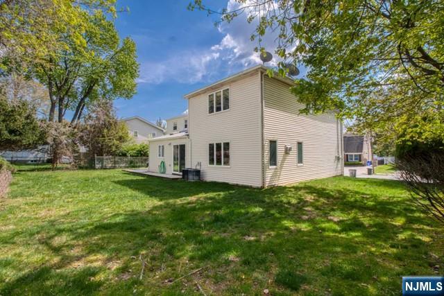 99 Park Avenue Cresskill, NJ 07626 - Photo 16 of 46 a view of a white house in front of a big yard with large trees