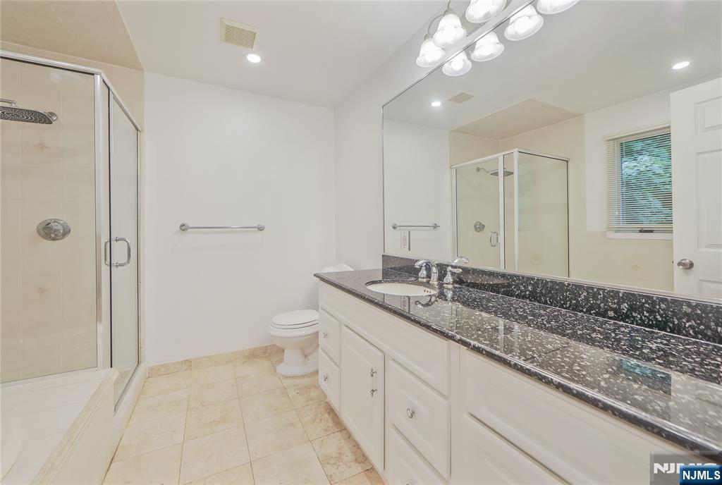 99 Park Avenue Cresskill, NJ 07626 - Photo 27 of 46 a spacious bathroom with a granite countertop sink a toilet and shower