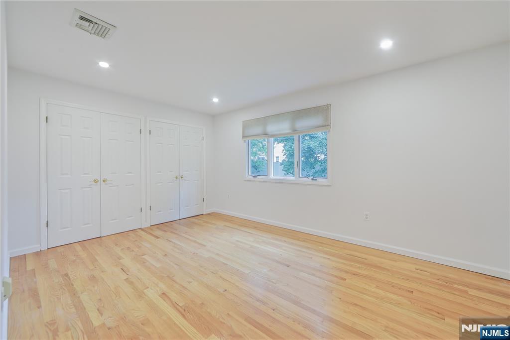 99 Park Avenue Cresskill, NJ 07626 - Photo 36 of 46 an empty room with wooden floor and windows