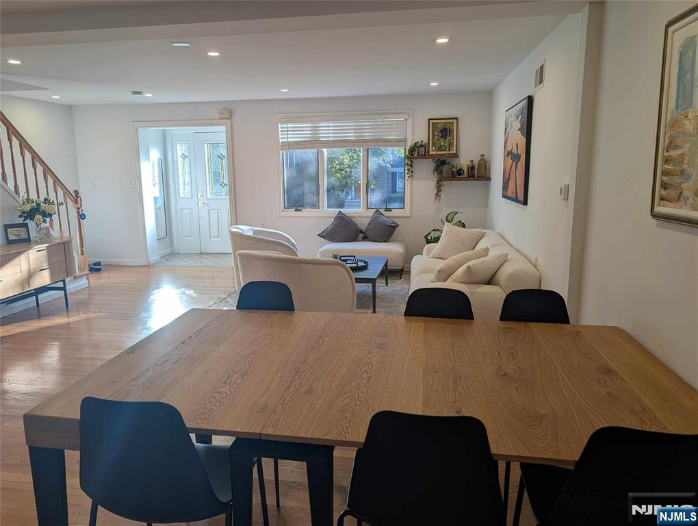 99 Park Avenue Cresskill, NJ 07626 - Photo 7 of 46 a living room with couches and a flat screen tv with kitchen view